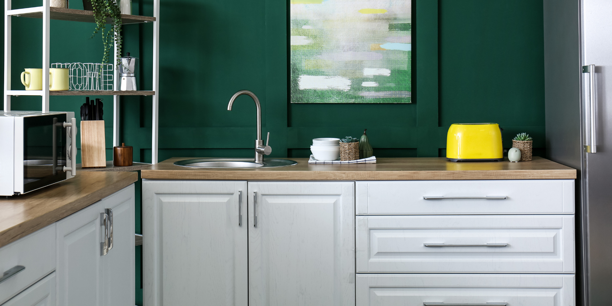 Modern kitchen design featuring sleek white cabinets, a central island with marble countertops, and stainless steel appliances, highlighting both style and functionality